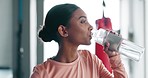 Woman, drinking water and fitness in gym with health, thirsty and wellness with workout, profile and hydration. Athlete, sport and h2o, liquid in plastic bottle and healthy with exercise and training