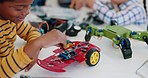 Boy, tech and robotics in classroom, learning or education for research, study and thinking with idea. School kids, science and electronics with toys, machine and development at academy for solution