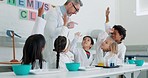 Raise hands, chemistry and teacher with children in a class for an experiment, study or research. Education, science and man scientist working with kid students for chemical reaction in a school lab.