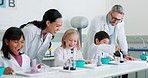 Chemistry, learning and teachers doing experiment with children for a project or test together. Education, science and team of scientists teaching kid students a chemical reaction for research in lab