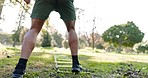 Park, workout and legs of man with agility ladder for training, jumping or physical performance outdoor. Ground, box and feet of male athlete on a field for fitness, exercise and sport speed movement
