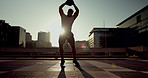 Sunset, city and a man with a slam ball for fitness, training or workout as a strong bodybuilder. Exercise, silhouette and body with a young athlete in an urban town for health or bodybuilding