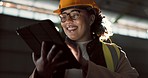 Industrial, tablet and woman construction worker in warehouse for engineering production project. Industry, digital technology and female engineer doing online research by an indoor site for storage.