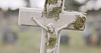 Funeral, tombstone or Jesus Christ on cross in cemetery for death ceremony, religion or memorial service. Symbol, background or Christian sign on gravestone for burial or loss in public graveyard