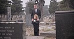 Child, death or father in graveyard for funeral. spiritual service or burial for respect in Christian religion. Rose, depressed or sad kid in cemetery for grief, loss or mourning with dad for support