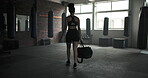 Gym, walking and woman with a bag for exercise, sports training or workout for wellness. Back of an athlete person morning arrival at health club to start fitness, strong body and commitment