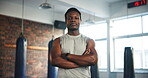 Gym, arms crossed and black man serious for exercise, training or confident workout, challenge or cardio. Coach, portrait and African bodybuilder with muscle building, fitness mindset or boxing club