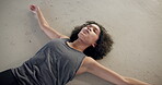 Dance, tired and a woman lying on the floor of a studio from above after fitness, exercise or a workout. Art, exhausted and breathing with a young ballerina on the ground while training as a dancer