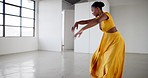 Ballet, performance and a woman dance in a creative art studio with energy and passion. Professional African dancer practice for theater, ballerina and freedom with balance, dress and talent