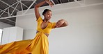 Dancing, dress and a black woman for performance in a creative art studio with energy and passion. Young contemporary dancer practice for theater, sports and freedom with balance, textile and talent