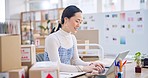 Ecommerce, Asian woman at laptop with typing and smile for sales report and work at fashion startup. Online shopping, boxes and small business owner with happiness, computer and website shop at desk.