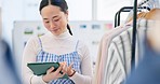 Fashion, small business and Asian woman with a tablet, store and retail with ecommerce, connection and search internet. Person, shop assistant and worker with technology, boutique and online shopping