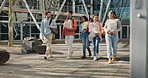 University, diversity and students walking on campus for education together in a corridor as friends with a scholarship. Learning, group and people in conversation happy in college or school hallway