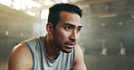 Fitness, face and breathing with a tired man in the gym, resting after an intense workout. Exercise, sweating and fatigue with a young athlete in recovery from training for health or wellness