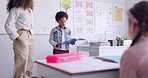 Child, kid reading and classroom with talking speaker, book and education at a school. Students, learning and notebook with development, knowledge and study with story discussion of youth assessment