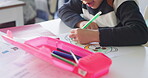 Creative, school and hands of child drawing in a classroom for art lesson for education and development in class. Closeup, kindergarten and kid or student learning artistic homework on a desk