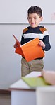 Boy, reading and book with presentation, school or oral assessment for info, development or language. Male kid, story and speech with test, literature and education in project, classroom or academy