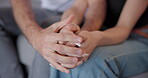 Couple, love and holding hands in home for care, help and support of empathy, gratitude or sorry. Closeup of man, woman and hand of partner for loyalty, healing and trust of kindness, hope or forgive