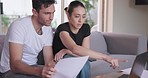 Couple, bills and laptop on sofa for budget, planning loan investment or financial administration at home. Man, woman and documents at computer for savings, tax report and online banking of insurance