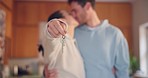 Couple, hands and kiss with keys in new home for moving together, property investment or real estate dream. Closeup, man and woman celebrate key to house building, financial security or mortgage loan