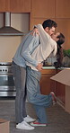 Love, kiss and hug with a couple in their new home together for celebration or real estate investment. Property, mortgage or growth with an excited man and woman embracing while moving house