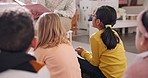 Education, storytelling and children on a floor with teacher in classroom with book, learning or child development. School, reading and student kids on the ground for listening or kindergarten lesson