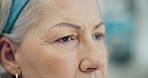 Closeup, thinking or senior woman with memory, retirement or sad in a living room. Old person, home or elderly lady with depression, lonely or alzheimer with dementia, anxiety or pensioner with grief