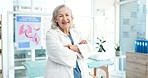 Crossed arms, confidence and face of senior woman doctor in her office in the hospital. Happy, smile and portrait of elderly female healthcare professional with pride standing in a medical clinic.