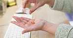 Closeup, hands and medicine while typing at a desk for sick, healthcare or a headache. Office, bottle and an employee with pills at a workspace for stress, pain or anxiety about business or email