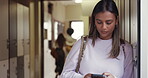 College student, woman and reading message on phone in hallway for serious text or online chat. Lonely indian girl in space at university with smartphone school social media network or website search