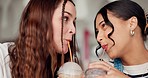 Happy, girl friends and milkshake in a restaurant with healthy drink and smile in cafe. Silly, young women and female bonding in a coffee shop or diner with a funny joke and drinking with smoothie