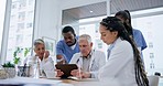 Healthcare, teamwork and group of doctors in discussion in the hospital boardroom for treatment plan. Diversity, meeting and team of medical workers planning and brainstorming for diagnosis in clinic