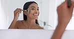 Woman, mirror and bathroom for skincare, roller and skincare with jade product, health or home in morning. Girl, cosmetics and dermatology with smile, wellness and self care for facial transformation