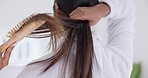 Hair, brush and woman hands in bathroom with beauty, wellness and morning routine in a home. Back, haircut care and keratin repair with a person with shampoo and house with cosmetics and hairbrush