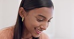 Happy, reading and a woman in a house for remote work, communication or relax. Smile, young and an Indian girl, freelance worker or entrepreneur in a home or bedroom for comfort, funny and face