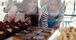 Display, window and women shopping in bakery for cake, dessert or pastry with friends together with happiness in store. Coffee shop, show and people excited for candy, food or sweets in glass