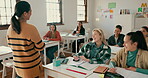 Education, college and a woman teacher in a class for learning, growth or development with a lesson. University, teaching and lecture with a young educator talking to students in an academy classroom