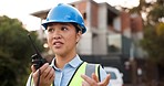 Communication, radio and construction worker, woman or manager for project management in urban city. Engineering leader, building contractor or asian person speaking for safety check on walkie talkie