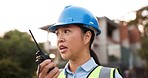 Asian woman, architect and walkie talkie in construction management, planning or communication on site. Female person, engineer or contractor talking on radio for architecture plan or discussion