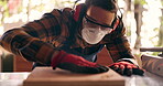 Wood, carpenter and dust with man in workshop for furniture, manufacturing and renovation. Production, tools and design with person and equipment in home garage for remodeling, board and handyman