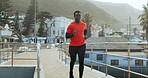 Black man, running in city with exercise and cardio, health and wellness with energy outdoor. Start, fitness and runner on urban bridge, healthy and active with workout, training and marathon race 