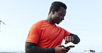 Fitness, time and black man with phone for performance, cardio tracking and mobile app for health outdoors. Sports, wellness and athlete check smart watch for marathon training, exercise and workout