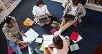 Students in library, people studying together and education, learning and discussion with books and technology. Top view, communication with young men and women, scholarship and academic group work