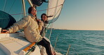 Sailing, yacht and friends at sea for holiday together as love, happiness and travel on romantic island location. Wind, boat and happy people with freedom on a cruise for luxury ocean  vacation