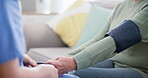 Blood pressure, test and hands of caregiver help senior on retirement with consultation on couch in home for support. Care, medical and nurse with advice for elderly person in healthcare exam on sofa
