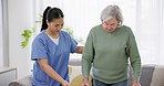 Homecare, support and senior woman with walker in living room with nurse for balance, support or rehabilitation. Nursing home, help and old lady patient with a disability, caregiver or physiotherapy