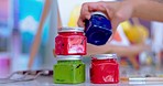 Paint, artist and hands of person with jar or container for painting hobby, design and creation. Art, creative and closeup of painter with products, color palette and canvas for creative drawing