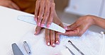 Hands on woman at spa, manicure and filing with technician for beauty, luxury grooming and cosmetics. Professional service, self care and girl at salon for aesthetic, wellness and file shape on nails