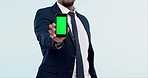 Green screen, phone and man in studio with mockup for social media, advertising or promo on white background. Smartphone, display and male model hands show app, platform or sign up, contact or info