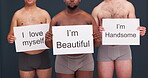 Beauty, self love and diversity with people and poster in studio for wellness, confidence and pride. Health, body positivity and message with men on dark background for support and empowerment